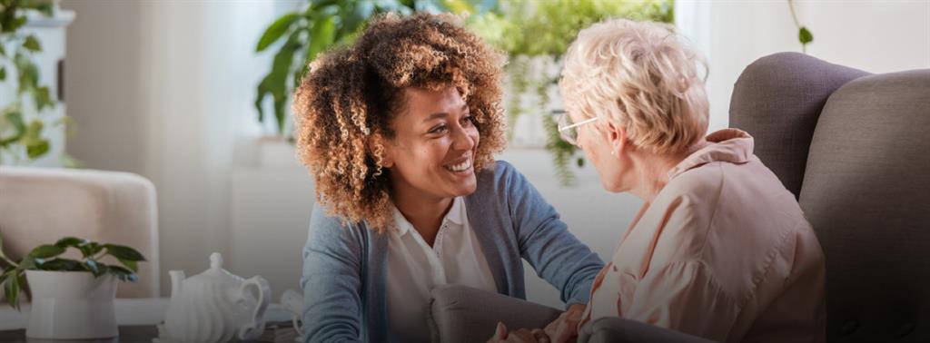 Two older adult couples , looking happy with a palm tree in the background